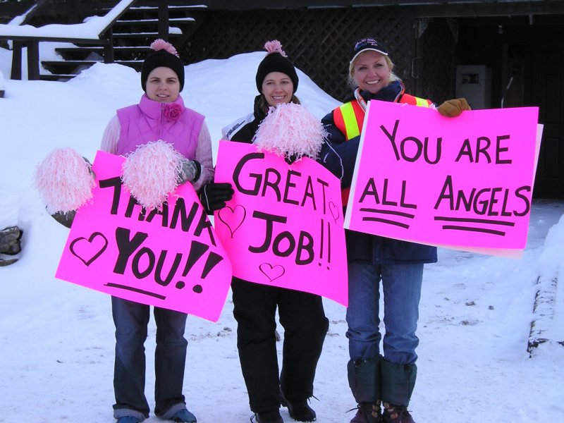 Ground volunteers cheering ladies on